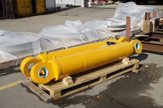 Two yellow hydrocylinders are on the pallet