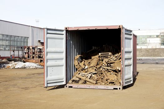 The scrap metal is in the open container