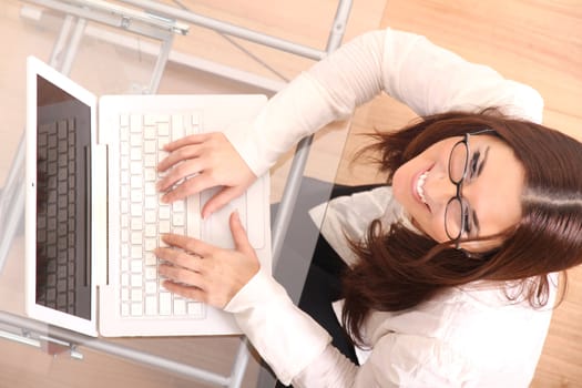 Cheerful business woman working on a Laptop.