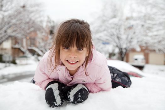 Little girl playing in the snow