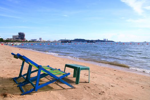 Couple of beach chairs and table on the beach in Pattaya City