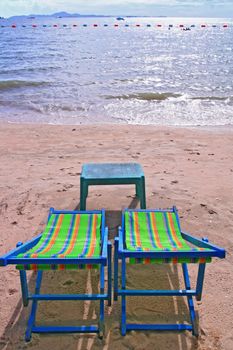 Couple of beach chairs and table on the beach in Pattaya City