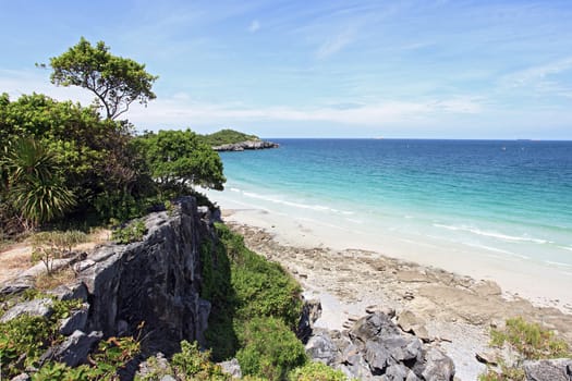 aerial view of beautiful white sand beach with cliff in sunny day