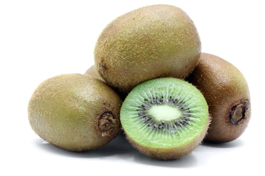 half and whole Kiwi fruit on white background
