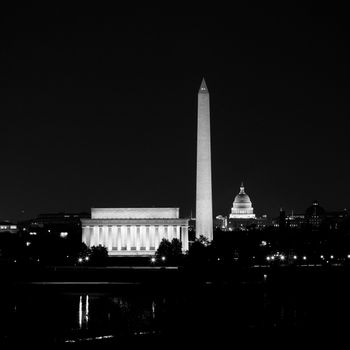 View of Washington DC skyline at night with lit up Lincoln Memorial, Washington Monument and the Capitol