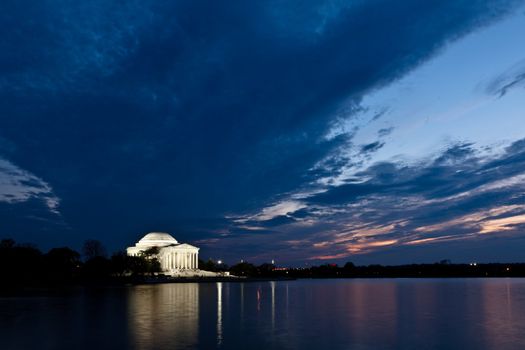 Thomas Jefferson Memorial with reflecting in the Tidal Basin in Washington DC at dusk shortly after sunset with dramatic skies