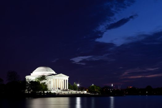 Thomas Jefferson Memorial with reflecting in the Tidal Basin in Washington DC at dusk shortly after sunset with dramatic skies