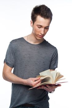Portrait of a young attractive guy who is preparing for the exams at a university or college