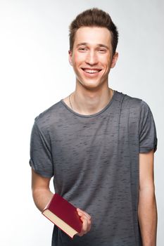 Portrait of a young attractive guy who is preparing for the exams at a university or college