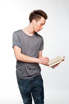 Portrait of a young attractive guy who is preparing for the exams at a university or college