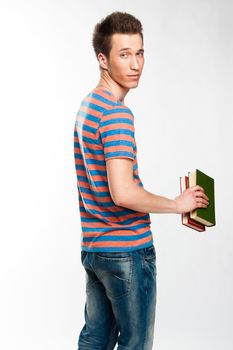 Portrait of a young attractive guy who is preparing for the exams at a university or college
