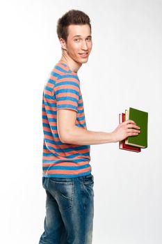 Portrait of a young attractive guy who is preparing for the exams at a university or college
