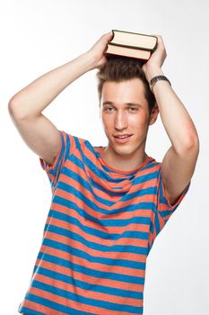 Portrait of a young attractive guy who is preparing for the exams at a university or college