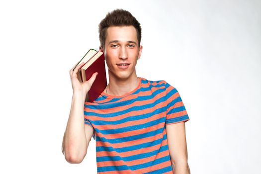 Portrait of a young attractive guy who is preparing for the exams at a university or college