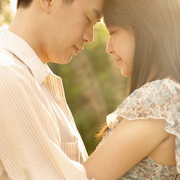 Asian couple enjoying in outdoor sunset