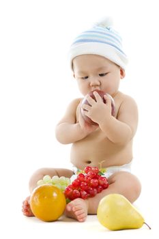 Pan Asian baby playing with fruits on white background