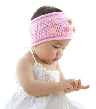 Asian baby girl playing with her hand