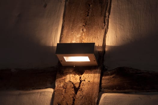 Old wooden framework facade with modern light