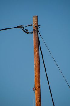 Telephone pole and wires in front of great blue sky