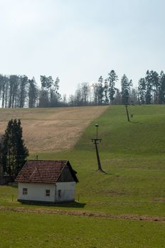 skilift in the mountains on a green lawn during the summer with valley station