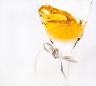 Wine inside a glass showing slight movement, image fades into and is isolated against a white background