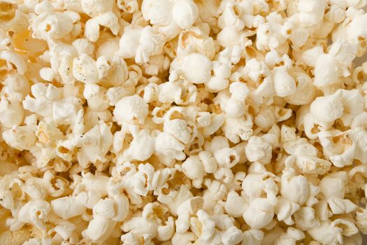 close up of popcorn with salt and pepper and lightly buttered and ready for a movie