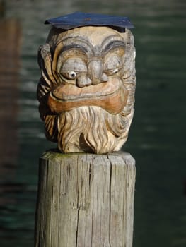 A carved face sculpture on pier