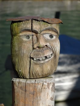 A carved face sculpture on pier