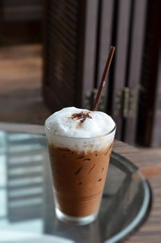 Cold coffee drink with ice on a  table