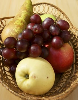 Fresh fruits in basket on table