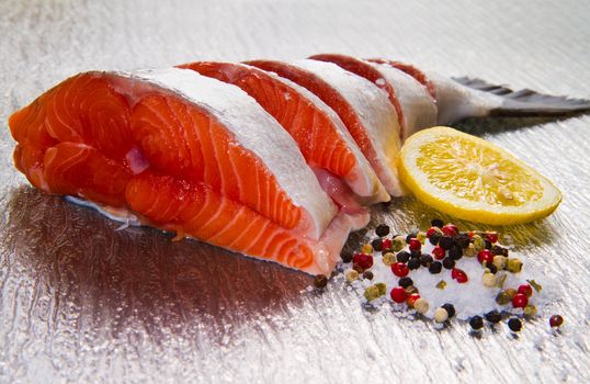 slice of fresh salmon with lemon , salt and pepper