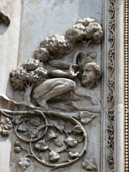 Orvieto - Duomo facade. The first pillar: scenes from Genesis. .Adam and Eve hide behind a tree.