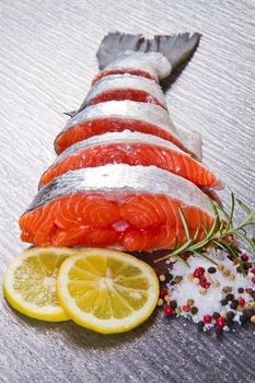 slice of fresh salmon with lemon , salt and pepper
