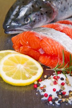 slice of fresh salmon with lemon , salt and pepper