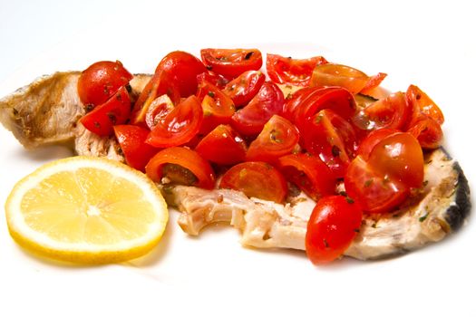 swordfish with tomatoes and lemon on white