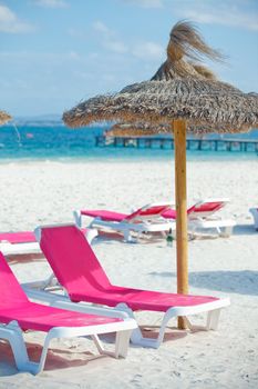 View of two chairs and umbrella on the beach. Vertical view