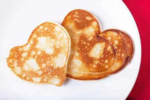 Two heart-shaped pancakes on a plate