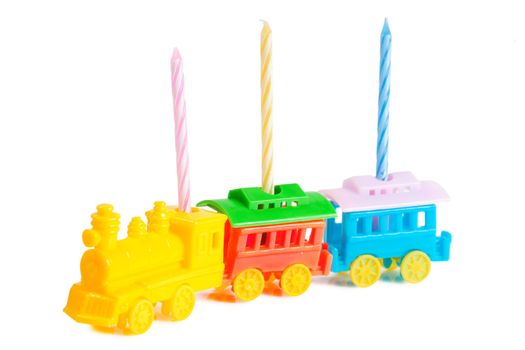 Three birthday candles in a train-shaped support