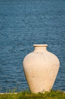 Big ancient vase in greek style for exterior with water on background