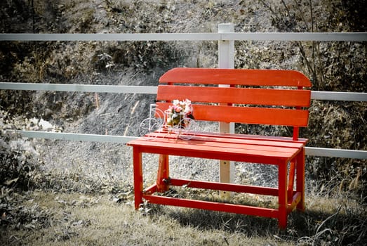 Red bench with bouquet in the garden, Retro style