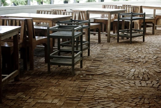 Old furniture in restaurant with old brick floor