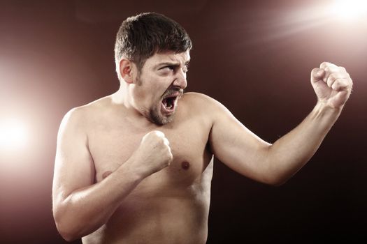 An image of a young man boxing and shouting