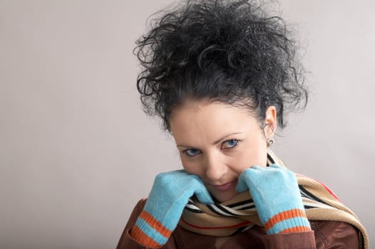 A blue-ayed girl in blue gloves and a scarf