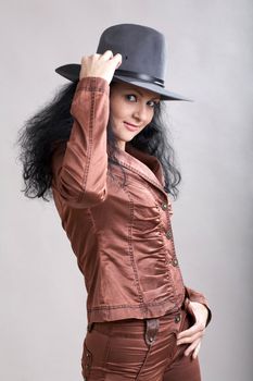 An image of a woman in felt hat. Shut in a studio.