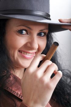 An image of a beautiful woman in felt hat with cigar