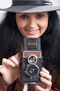 An image of woman with camera in studio