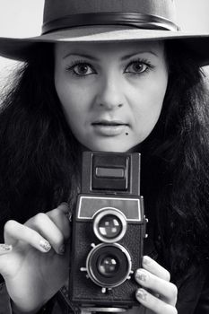 An image of photographer-girl with retro camera