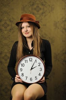 An image of a nice woman with a clock