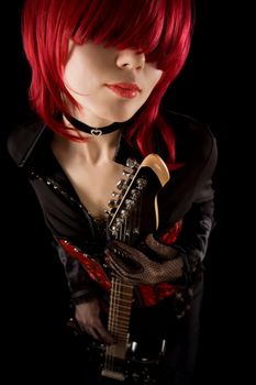 Girl with red make-up playing guitar, high angle view 