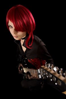 Redhead girl with guitar, selective focus on face, high angle view 